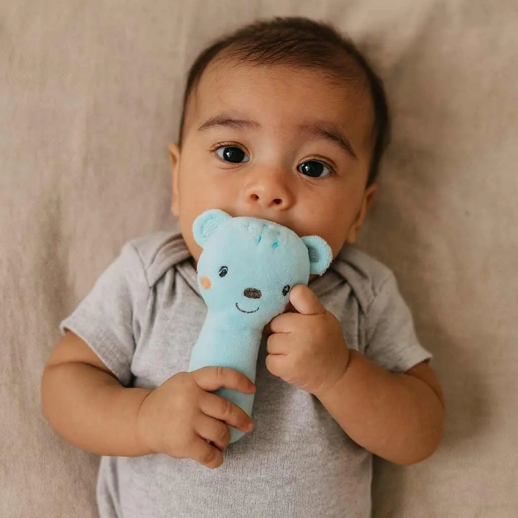 bébé avec son hochet ourson bleu